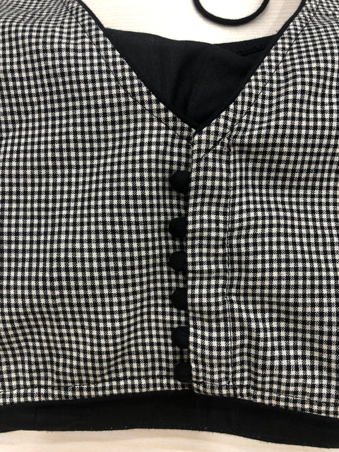 Small checked sleeveless blouse